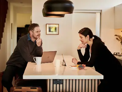 A man and a woman talking over coffee